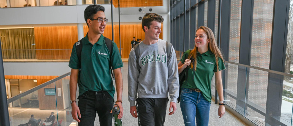 Undergraduate students in Broad College apparel walk the halls of the Minskoff Pavilion