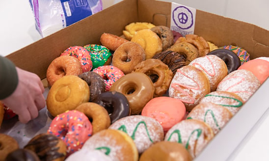 A box of colorful glazed doughnuts from Groovy Donuts