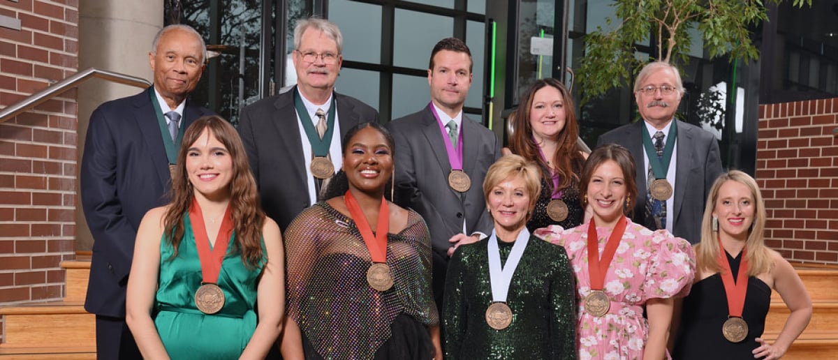 Ten MSU alumni who received awards, each wearing a medal