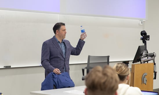 David Feber holds up a plastic water bottle
